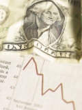 Crumpled American Dollar Bill on Red Graph of Economic Loss
