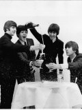 Beatles Sitting Round a Table with Glasses of Champagne