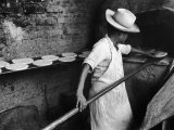 Communal Bakery in Primitive Mexican Village, Loaves of Bread Being Shoved into Adobe Oven